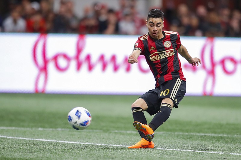 Atlanta United midfielder Miguel Almiron (10) shoots and scores in the second half of an MLS soccer game against the D.C. United on Sunday, March 11, 2018, in Atlanta. The Atlanta United won the game 3-1. (AP Photo/Todd Kirkland)