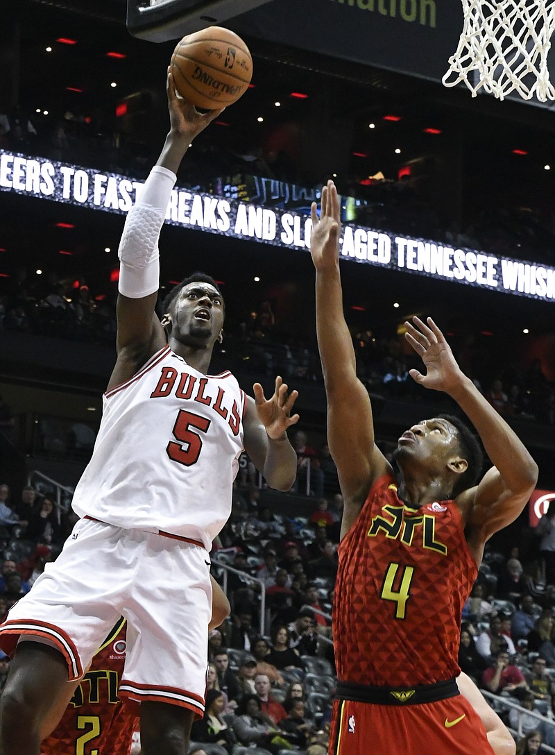 Chicago Bulls forward Bobby Portis (5) shoots as Atlanta Hawks forward Andrew White defends during the second half of an NBA basketball game Sunday, March 11, 2018, in Atlanta. (AP Photo/John Amis)