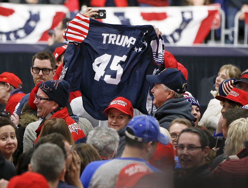 Supporters wave a jersey supporting President Donald Trump before he arrives for a campaign rally for a Pennsylvania congressional candidate last weekend.