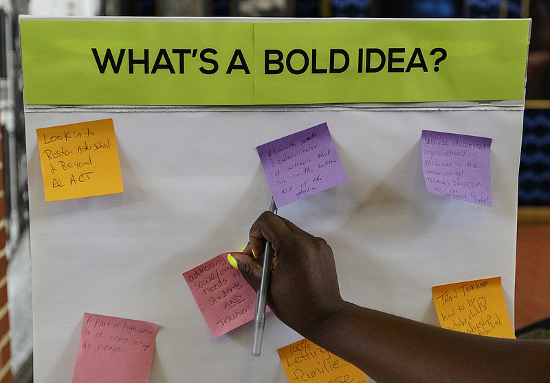 Staff photo by Doug Strickland / Sarah Lane puts her suggestion for a "bold idea" on a board at a welcome reception for new Hamilton County Schools Superintendent Bryan Johnson hosted by the Urban League of Greater Chattanooga, Chattanooga 2.0, and UnifiEd last August.