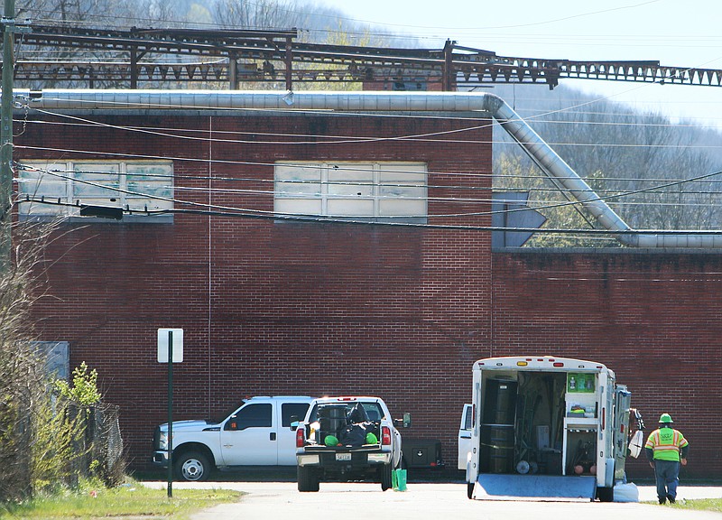 An an SRT Safety team works along a blocked off portion of Williams Street and Maple Street in front of the abandoned Coats American building Monday, March 12, 2018 in Rossville, Ga., where an oil spill with Polychlorinated biphenyls was discovered. Police suspect copper thieves caused the spill.