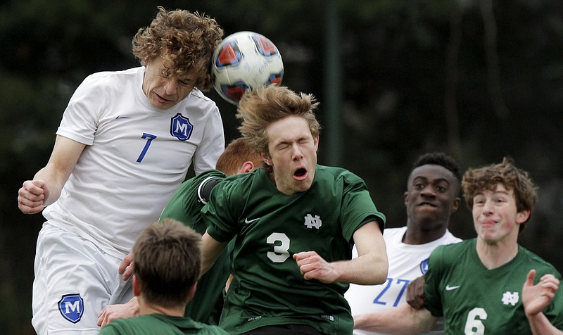 McCallie's Jonah Bryan (7) and Notre Dame's Trent Sutton (3) go up for the ball on either side of Notre Dame's Justin Hensley at McCallie School on Monday, March 12, 2018 in Chattanooga, Tenn. McCallie won 2-0, with goals by Will Hart and Ben Brock.


