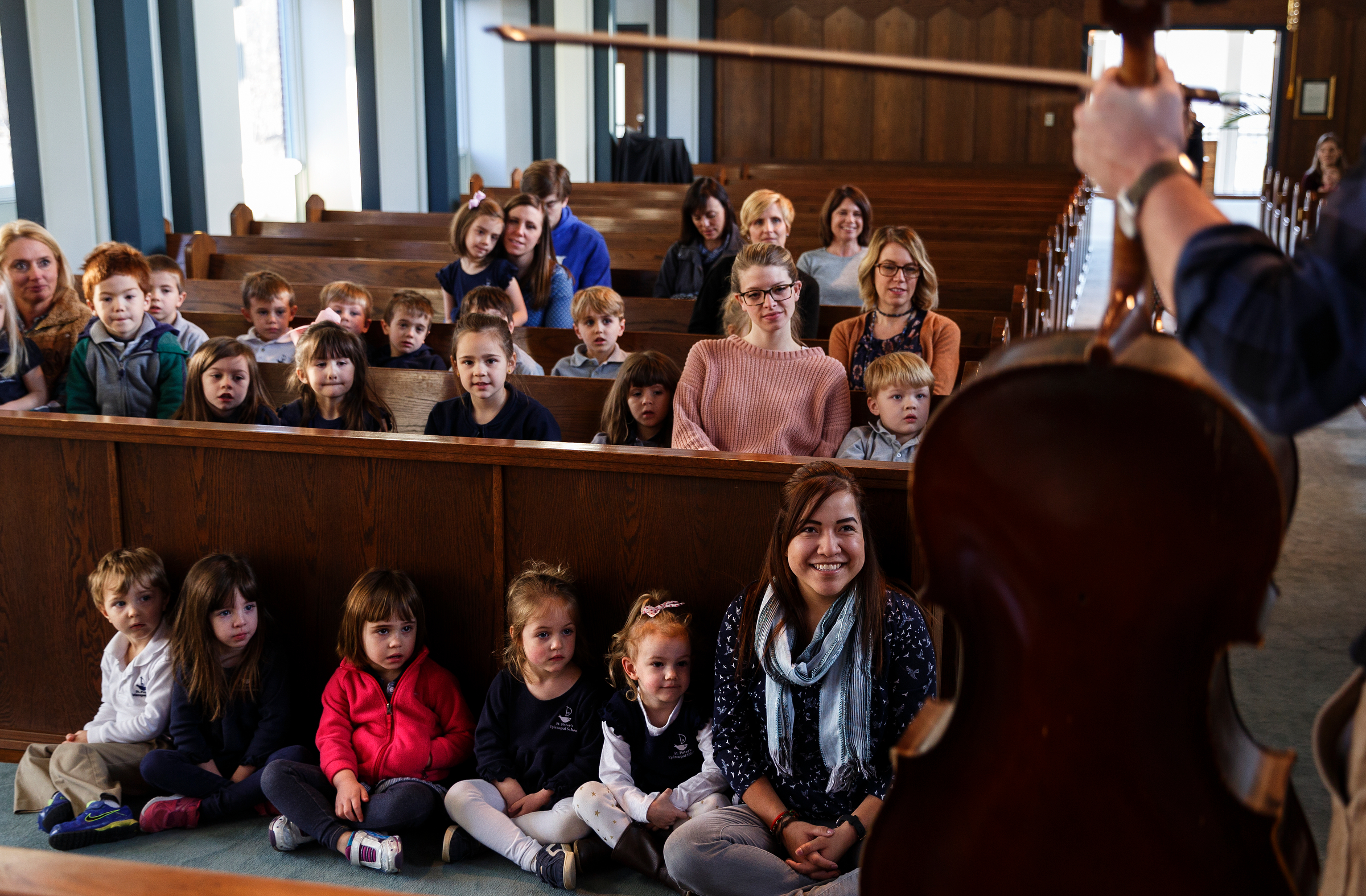 Students listen as cellist Ben Sollee talks about music during a workshop at St. Peter's Episcopal School on Tuesday, March 13, 2018, in Chattanooga, Tenn. Sollee, a musician known for touring by bicycle, offered students an introduction to the musical sounds of the cello while also talking about his journey to find his own musical voice.