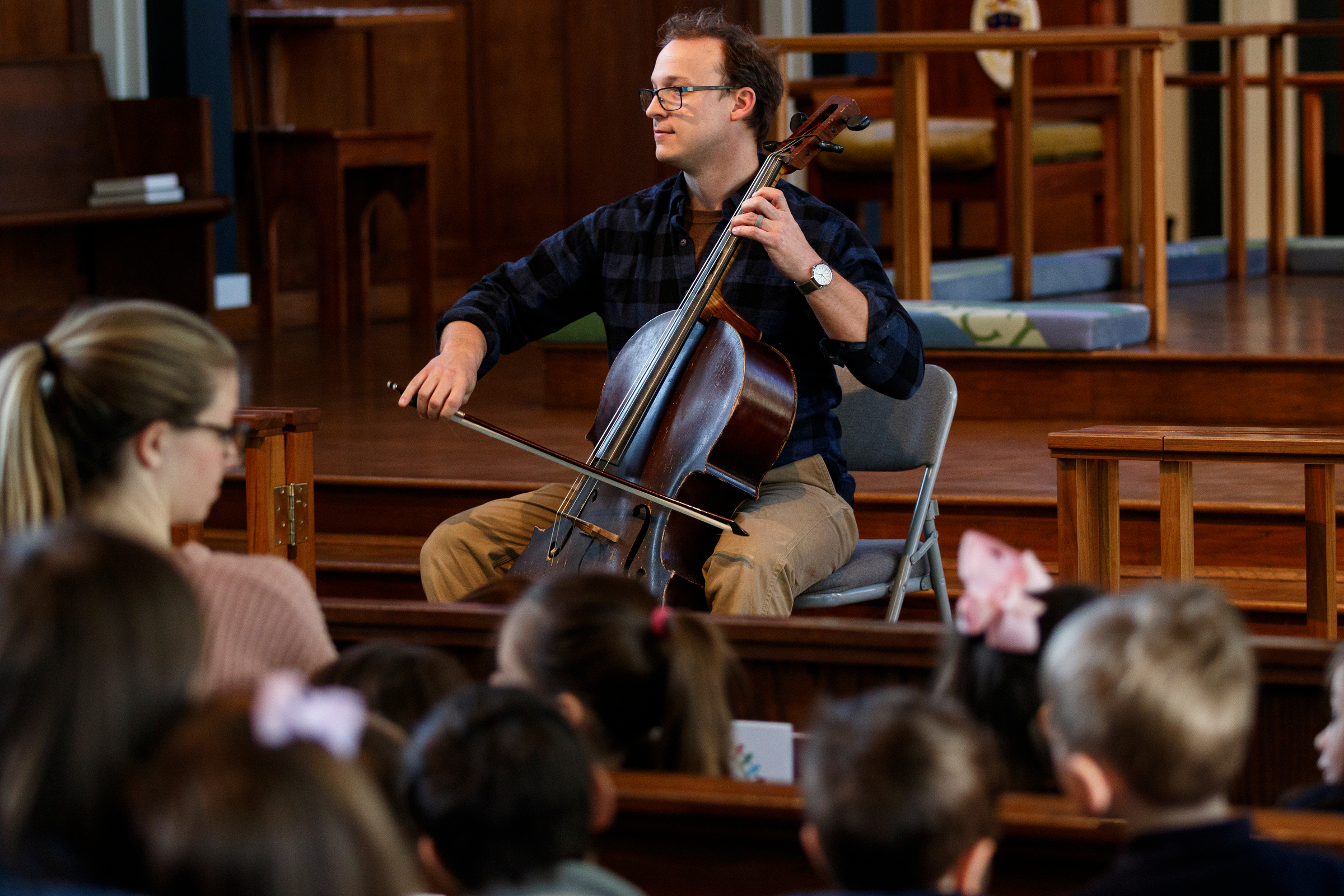 Cellist Ben Sollee performs for students during a workshop at St. Peter's Episcopal School on Tuesday, March 13, 2018, in Chattanooga, Tenn. Sollee, a musician known for touring by bicycle, offered students an introduction to the musical sounds of the cello while also talking about his journey to find his own musical voice.