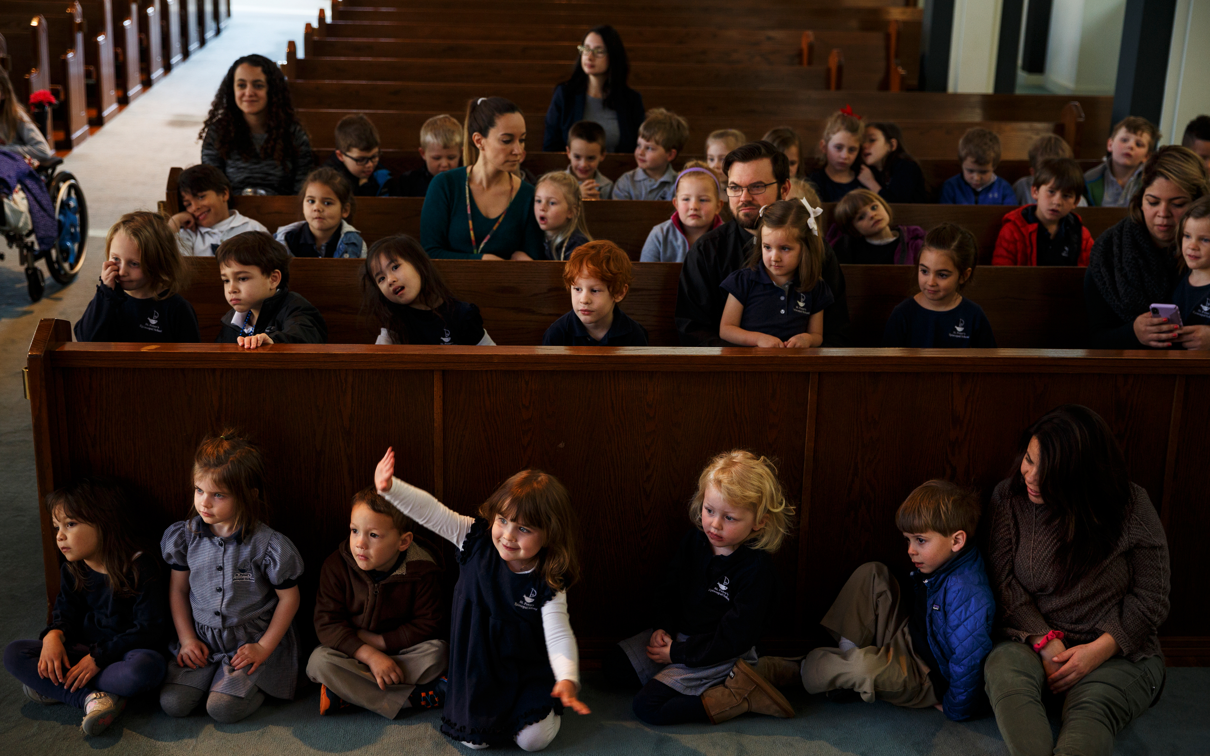 Students listen as cellist Ben Sollee performs during a workshop at St. Peter's Episcopal School on Tuesday, March 13, 2018, in Chattanooga, Tenn. Sollee, a musician known for touring by bicycle, offered students an introduction to the musical sounds of the cello while also talking about his journey to find his own musical voice.