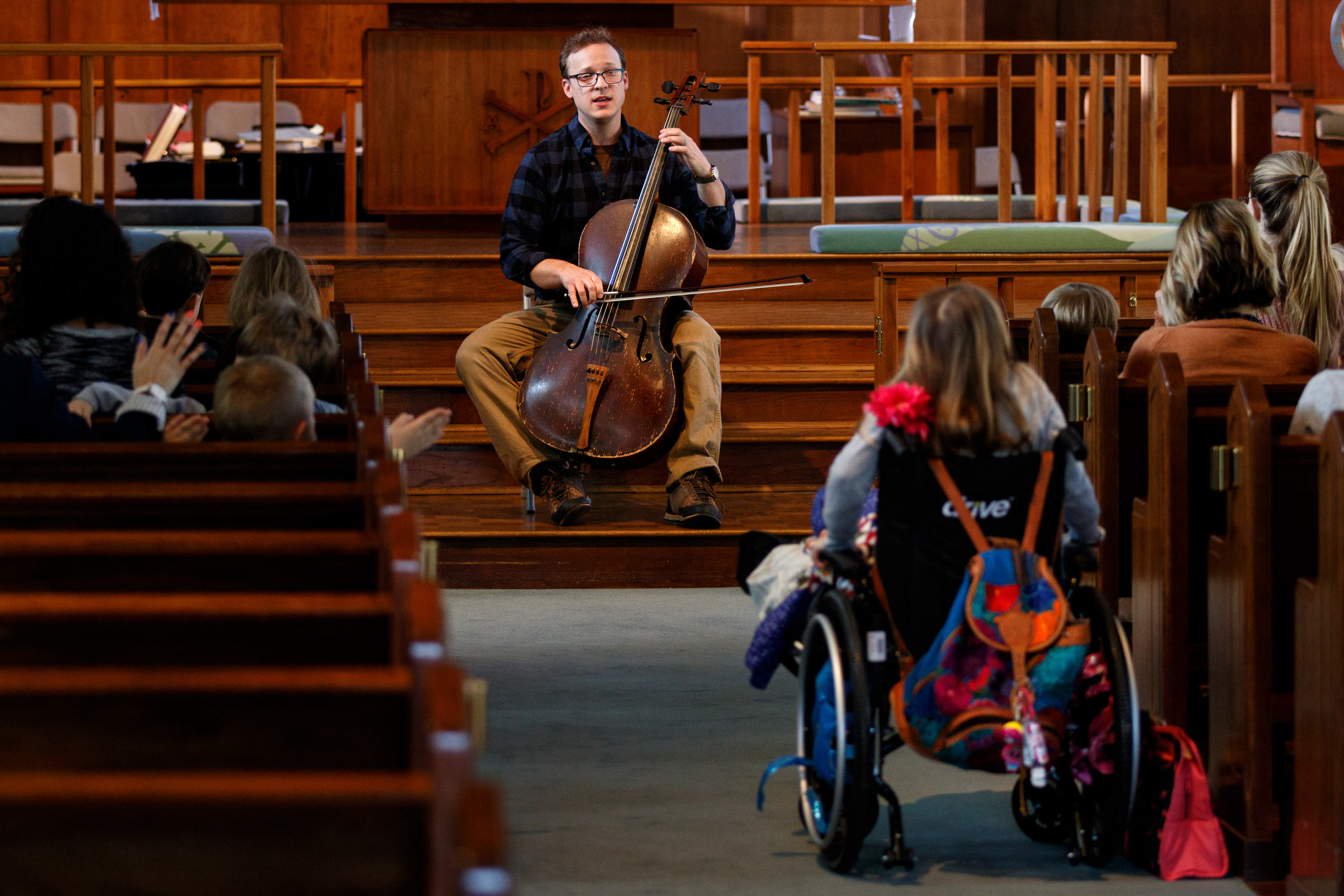 Cellist Ben Sollee performs for students during a workshop at St. Peter's Episcopal School on Tuesday, March 13, 2018, in Chattanooga, Tenn. Sollee, a musician known for touring by bicycle, offered students an introduction to the musical sounds of the cello while also talking about his journey to find his own musical voice.