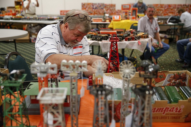 Chuck Campbell assembles a model oil tower at last year's Dixie Division of the Train Collectors Association train show. (Staff File Photo by Doug Strickland)