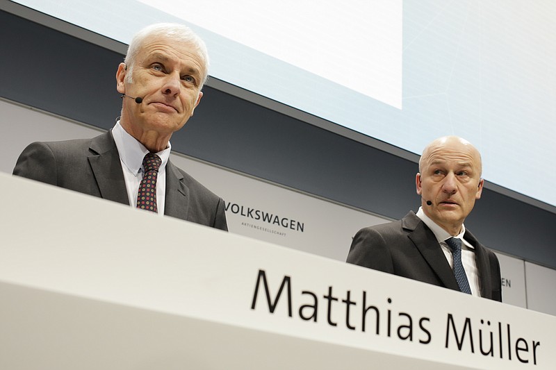 VW group CEO Matthias Mueller, left, and CFO Frank Witter, right, arrive for the annual media conference of the Volkswagen group, in Berlin, Germany, Tuesday, March 13, 2018. (AP Photo/Markus Schreiber)