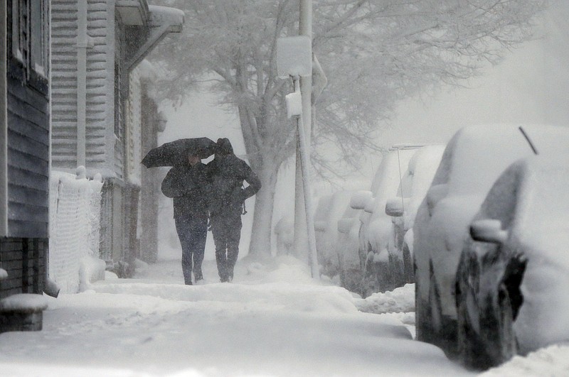 A couple walks on Marginal Street in Boston, Tuesday, March 13, 2018. The National Weather Service issued a blizzard warning for much of the coast of Maine, New Hampshire, and Massachusetts. (AP Photo/Michael Dwyer)