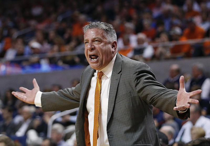 FILE - In this March 3, 2018, file photo, Auburn head coach Bruce Pearl reacts on the sidelines during the first half of an NCAA college basketball game against South Carolina, in Auburn, Ala. Pearl, a coach with an out-sized personality and checkered past, has led Auburn to its first NCAA Tournament in 15 years and a surprising SEC title but still faces questions about his job security amid an internal review of the program. (AP Photo/Brynn Anderson, File)