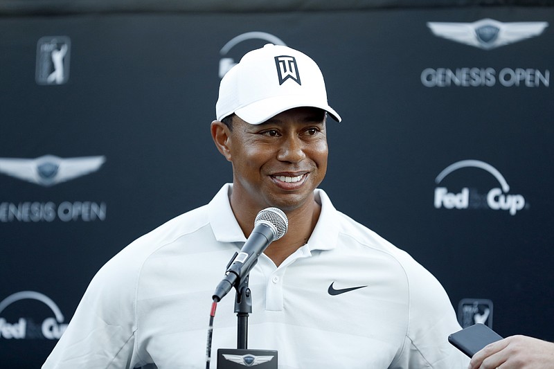FILE - In this Feb. 16, 2018, file photo, Tiger Woods talks to reporters following his second round of the Genesis Open golf tournament at Riviera Country Club in the Pacific Palisades area of Los Angeles. Tiger Woods and Ernie Els will duel in the Presidents Cup again, this time as captains. Woods and Els have agreed to be captains for the 2019 matches in Melbourne, Australia, according to two people involved in the Presidents Cup. They spoke on condition of anonymity because the captain selections have not been announced. (AP Photo/Ryan Kang, File)