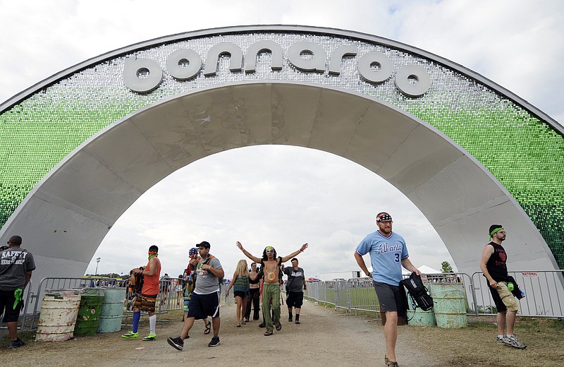 FILE - In this June 13, 2014 file photo, festival-goers enter through the arch during Bonnaroo Music & Arts Festival in Manchester, Tenn. Concert promoter and ticket seller Live Nation on Tuesday, April 28, 2015 said that it bought a controlling stake in the annual music festival. (AP Photo/The Knoxville News Sentinel, Adam Lau, File)