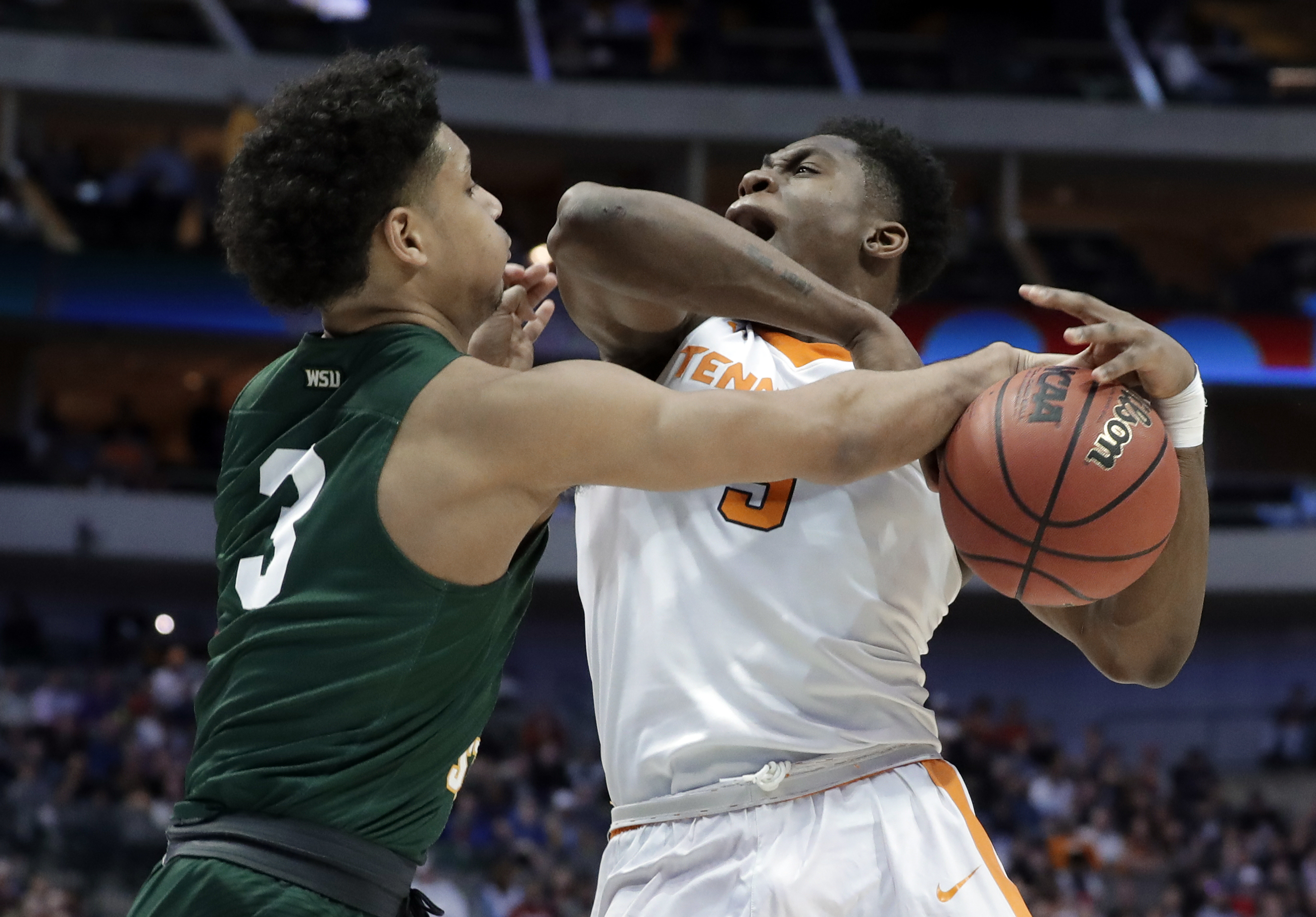 Wright State guard Mark Hughes (3) blocks a drive to the basket by Tennessee forward Admiral Schofield (5) in the first half of a first-round game in the NCAA college basketball tournament in Dallas, Thursday, March 15, 2018. (AP Photo/Tony Gutierrez)