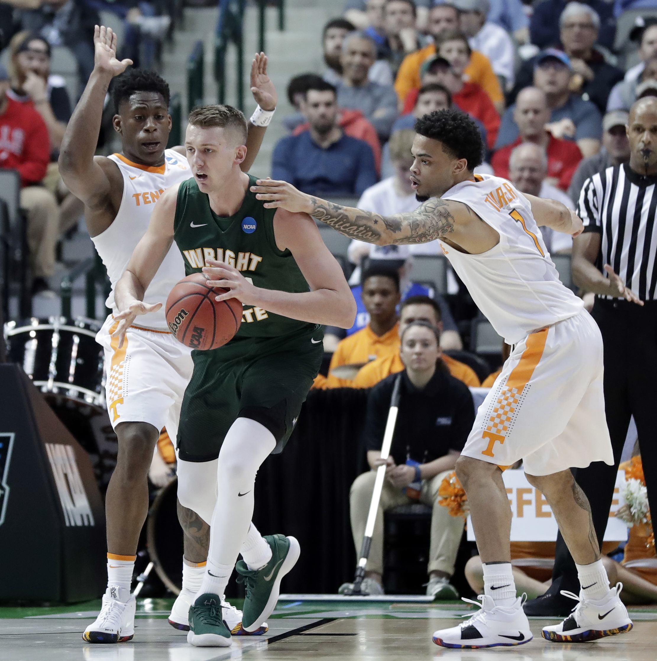 Wright State center Parker Ernsthausen (22) works for a shot as Tennessee forward Admiral Schofield, left, and guard Lamonte Turner (1) defend in the first half of a first-round game in the NCAA college basketball tournament in Dallas, Thursday, March 15, 2018. (AP Photo/Tony Gutierrez)