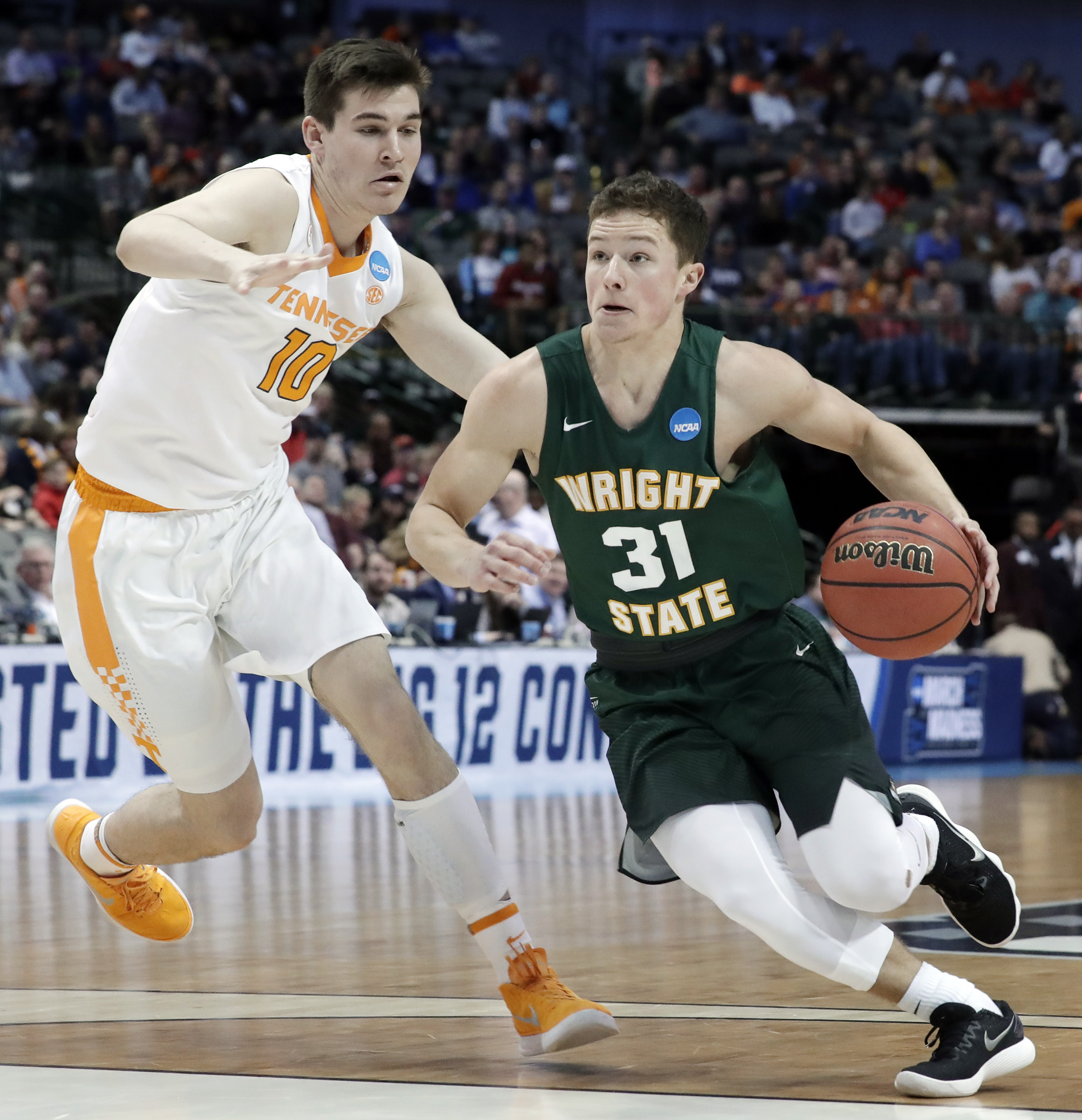 Tennessee forward John Fulkerson (10) defends as Wright State guard Cole Gentry (31) drives to the basket during the second half in the first round of the NCAA men's college basketball tournament in Dallas, Thursday, March 15, 2018. (AP Photo/Tony Gutierrez)