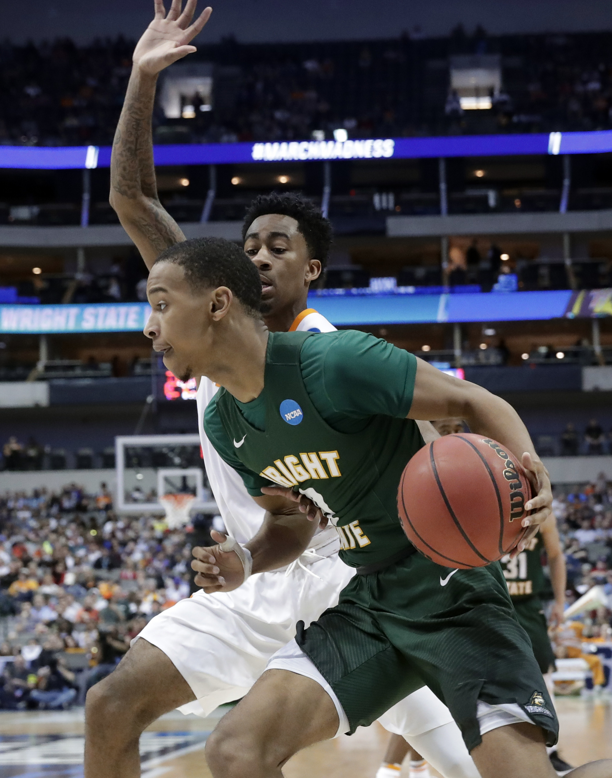 Wright State guard Jaylon Hall (0) drives to the basket as Tennessee guard Jordan Bowden, rear, defends in the second half in the first round of the NCAA college basketball tournament in Dallas, Thursday, March 15, 2018. (AP Photo/Tony Gutierrez)