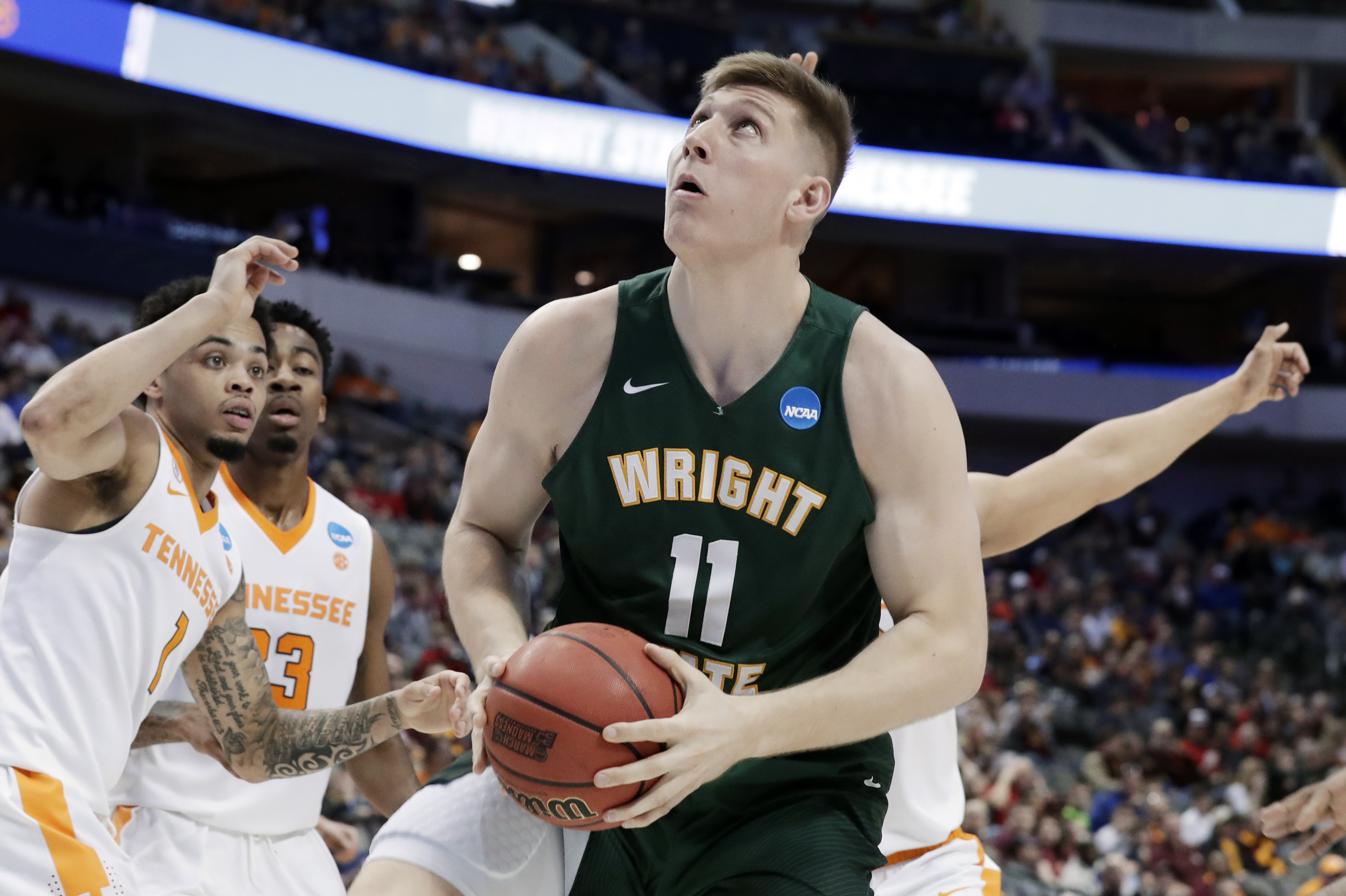 Wright State center Loudon Love (11) works to the basket as Tennessee guard Lamonte Turner (1) and Jordan Bowden (23) defend in the second half in the first round of the NCAA college basketball tournament in Dallas, Thursday, March 15, 2018. (AP Photo/Tony Gutierrez)