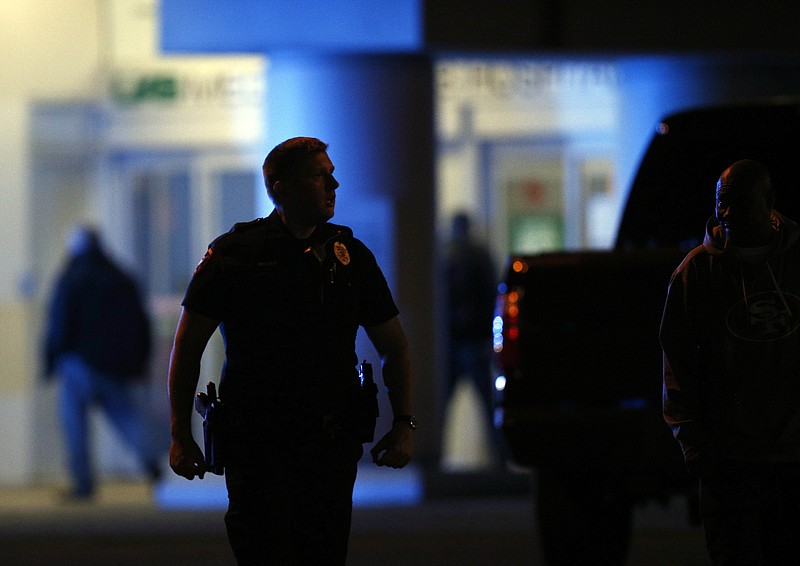Authorities respond to a gunman that opened fire at a Birmingham, Alabama, hospital, wounding two men before turning the gun on himself Wednesday night, police said on Wednesday, March 14, 2018, in Birmingham, Ala. (AP Photo/Brynn Anderson)