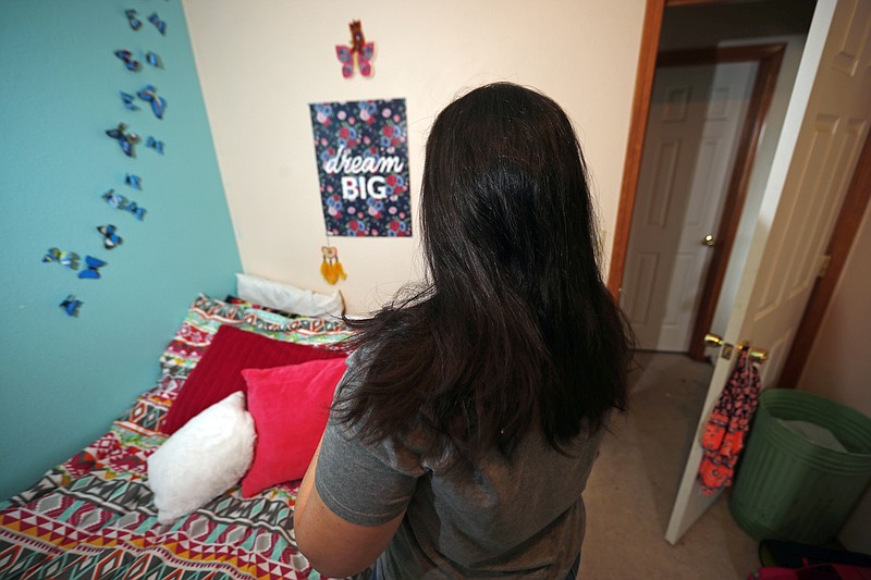 
              FILE - In this Jan. 31, 2018 file photo, a mother whose daughter said she was sexually assaulted during first grade by a classmate at their elementary school on a U.S. military base in Germany, stands in her daughter's bedroom at their new home in Colorado. On Thursday, March 15, 2018, senior members of Congress called for investigations and a hearing following an Associated Press report that details how the U.S. military frequently fails to protect or provide justice to the children of service members when they sexually assault each other on base. (AP Photo/David Zalubowski, File)
            