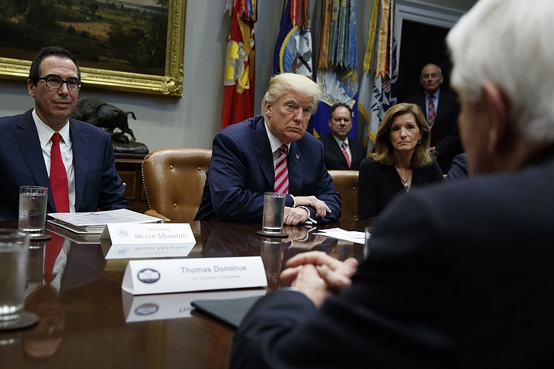 In this Oct. 31, 2017, file photo, Tom Donohue, President and CEO, U.S. Chamber of Commerce, foreground, speaks as Treasury Secretary Steve Mnuchin, left, President Donald Trump, second from left, and Karen Kerrigan, President and CEO, Small Business & Entrepreneurship Council, listen during a meeting in Washington. The U.S. Chamber of Commerce is warning Trump against slapping big tariffs on Chinese imports. "Simply put, tariffs are damaging taxes on American consumers,'' Donohue said in a statement. (AP Photo/Evan Vucci, File)