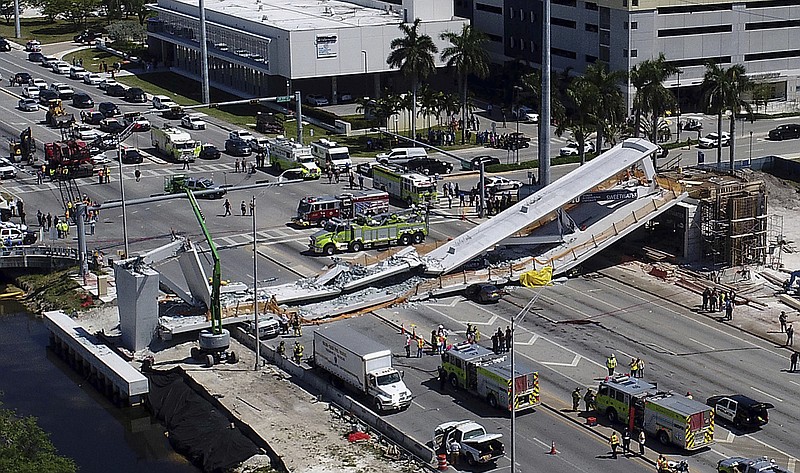 Emergency personnel respond after a brand-new pedestrian bridge collapsed onto a highway at Florida International University in Miami on Thursday, March 15, 2018.