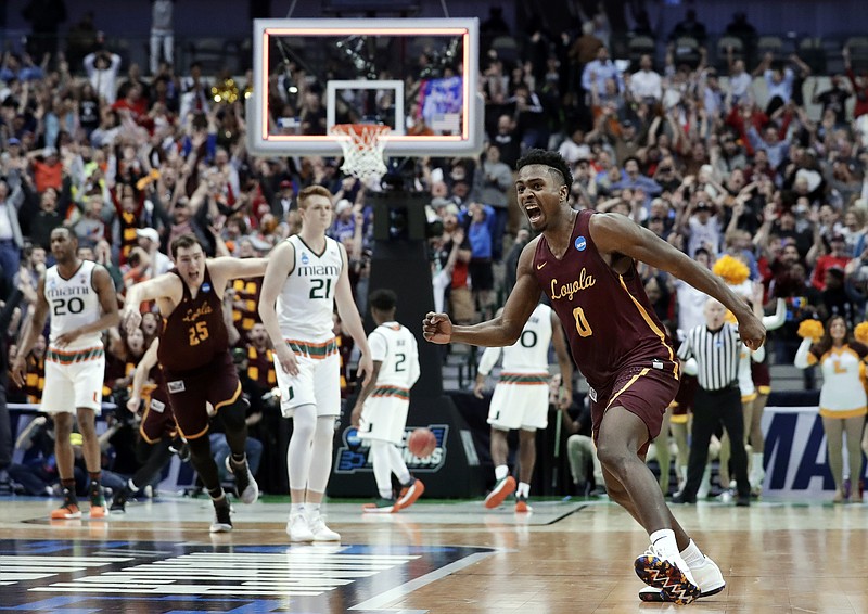 Loyola-Chicago guard Donte Ingram (0) celebrates sinking a 3-point basket in the closing seconds of the second half of a first-round game against Miami at the NCAA college basketball tournament in Dallas, Thursday, March 15, 2018. Loyola-Chicago won 64-62. (AP Photo/Tony Gutierrez)