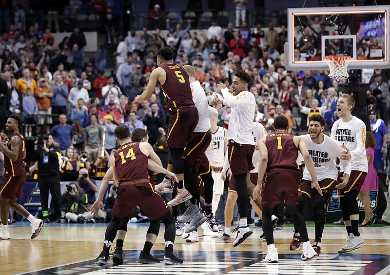 Loyola-Chicago celebrates in the closing seconds of their 64-62 win against Miami in a first-round game at the NCAA college basketball tournament in Dallas, Thursday, March 15, 2018. (AP Photo/Tony Gutierrez)