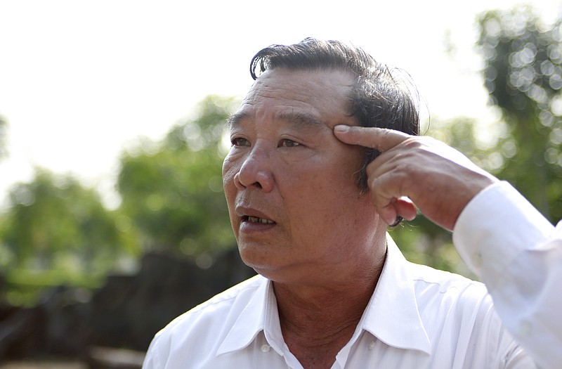 In this Wednesday, March 14, 2018, photo, massacre survivor Pham Thanh Cong points at a scar caused by grenade fragments during the My Lai massacre in Son My, Vietnam. On March 16, 1968, U.S soldiers of Charlie Company, sent on what they were told was a mission to confront a crack outfit of their Vietcong enemies, met no resistance, but over the course of three to four hours killed 504 unarmed civilians, mostly women, children and the elderly, in My Lai and a neighboring community. Cong's mother and his four siblings were killed; he survived, protected underneath their torn bodies. (AP Photo/Hau Dinh)
