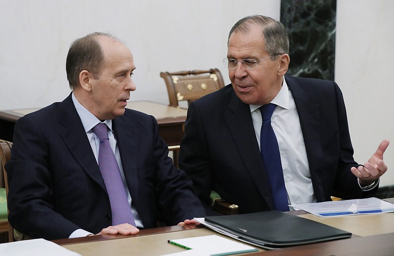 Russian Foreign Minister Sergey Lavrov speaks to Federal Security Service (FSB) Director Alexander Bortnikov as they attend a security council meeting in the Kremlin in Moscow, Russia, Thursday, March 15, 2018. Lavrov said Thursday that Moscow would "certainly" expel some British diplomats in a tit-for-tat response. In remarks carried by the RIA Novosti news agency, Lavrov said the move would come "soon." (Mikhail Klimentyev, Sputnik, Kremlin Pool Photo via AP)
