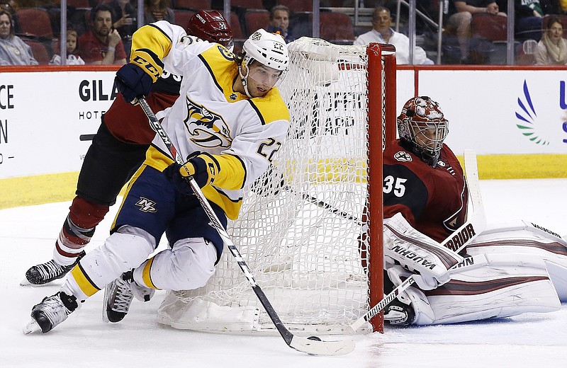 Nashville Predators left wing Kevin Fiala (22) tries to shoot against Arizona Coyotes goaltender Darcy Kuemper (35) during the first period of an NHL hockey game Thursday, March 15, 2018, in Glendale, Ariz. (AP Photo/Ross D. Franklin)