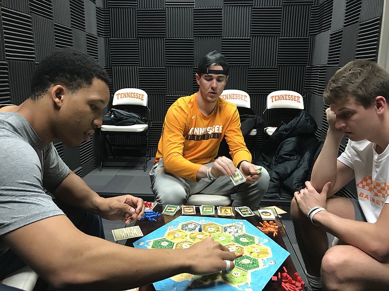 Grant Williams, Brad Woodson and Lucas Campbell play Settlers of Catan on a road trip during the 2017-18 season.