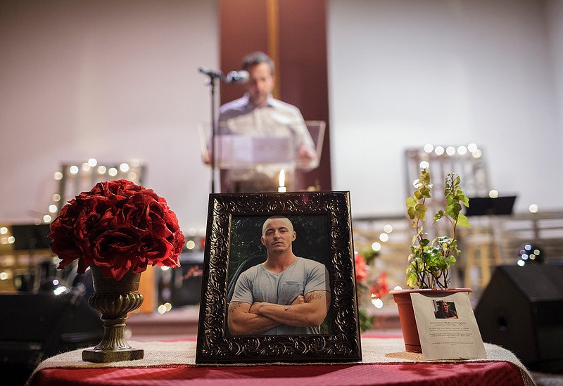 A picture of Noah Brandon Davis, who has been missing since 2015, is seen as his half-brother Justin Stephens speaks during a vigil held at Sonrise Community Church on Saturday, March 17, 2018, in Rossville, Ga. 