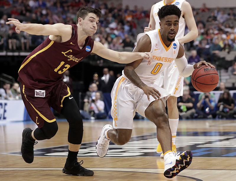 Loyola-Chicago guard Clayton Custer (13) gives chase as Tennessee guard Jordan Bone (0) works toward the basket during the first half of a second-round game at the NCAA men's college basketball tournament in Dallas, Saturday, March 17, 2018. (AP Photo/Tony Gutierrez)