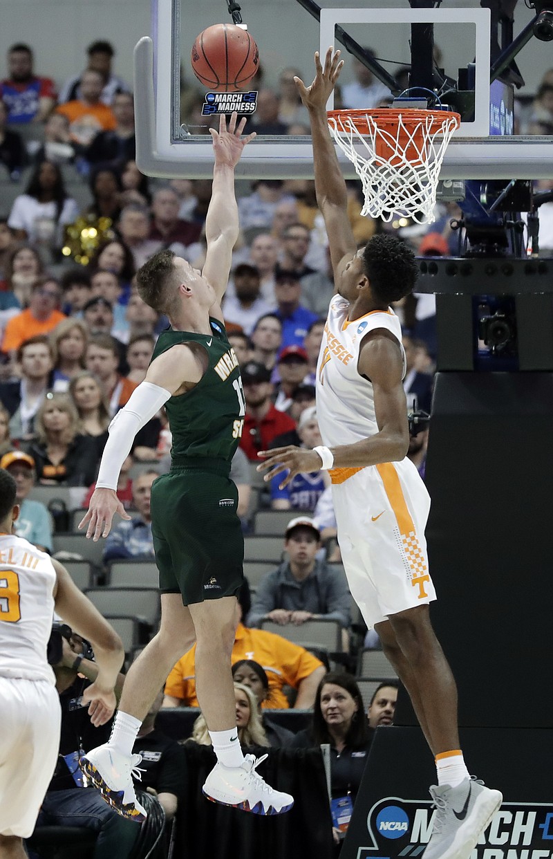 Wright State guard Grant Benzinger, left, drives to the basket as Tennessee forward Kyle Alexander defends during an NCAA tournament first-round matchup Thursday in Dallas. Alexander was injured in the game and did not play in the Vols' second-round loss Saturday night.