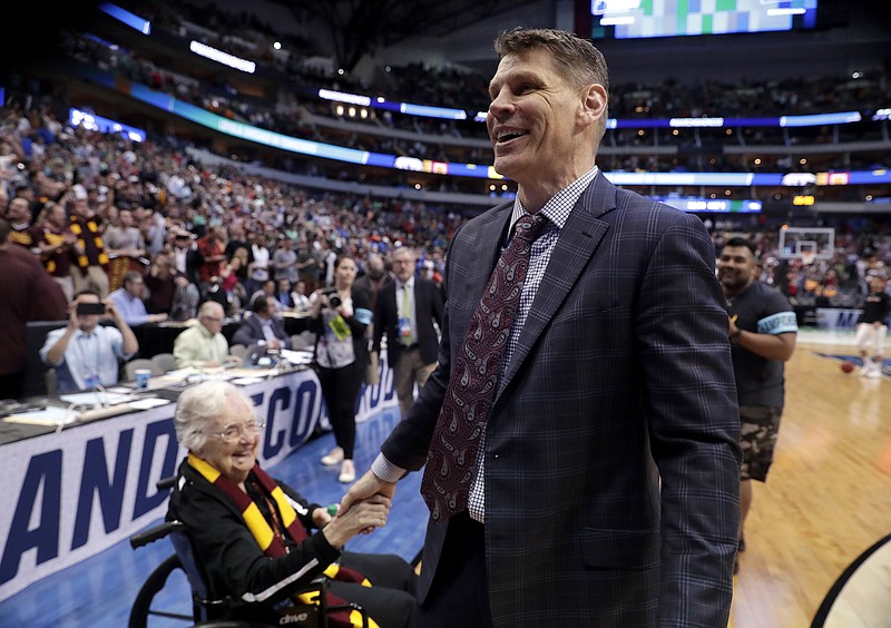Team chaplain Sister Jean Dolores Schmidt greets Loyola-Chicago coach Porter Moser after the team's 63-62 win over Tennessee in the second round of the NCAA men's basketball tournament.