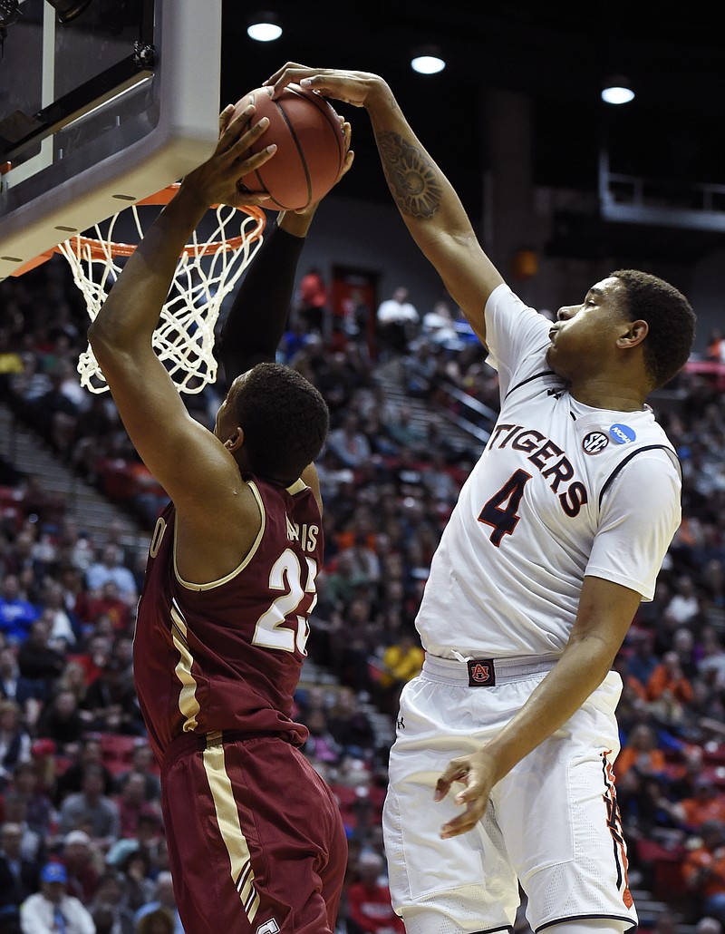 Auburn forward Chuma Okeke (4) blocks a shot and fouls Charleston forward Nick Harris (23) during the first half of a first-round NCAA college basketball tournament game Friday, March 16, 2018, in San Diego. (AP Photo/Denis Poroy)