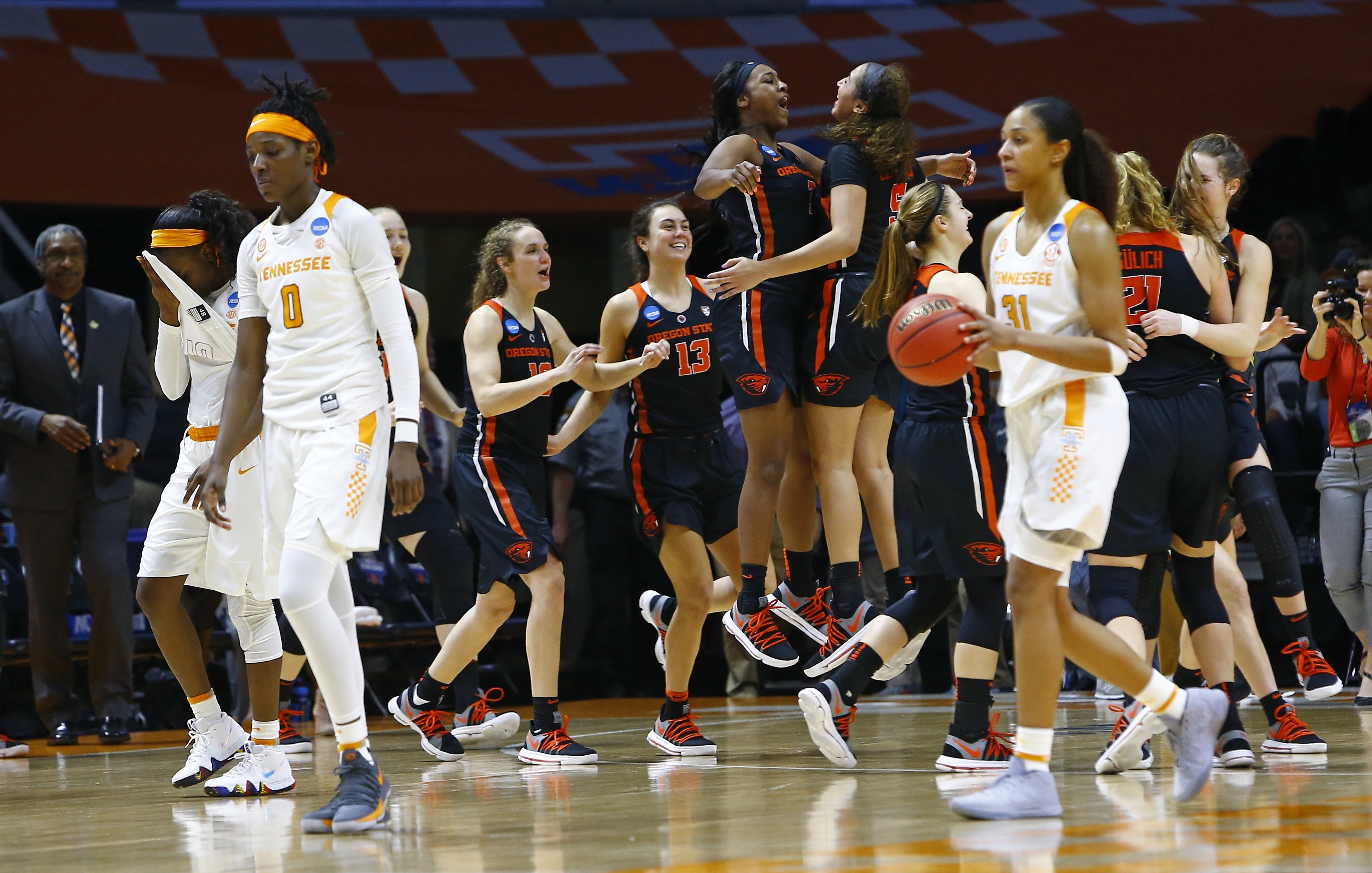 Members of the Oregon State women's basketball team celebrate as Tennessee's Rennia Davis (0) and Jaime Nared (31) walk off the court after the Lady Vols lost 66-59 in an NCAA tournament second-round matchup Sunday in Knoxville. Tennessee lost at home in the NCAA tournament for the first time, a span of 58 games. The Lady Vols failed to reach the Sweet 16 for the second consecutive season.