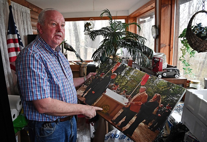 Retired Col. Gerald York shows a photo taken as he and his father attended a ceremony near Chatel-Chehery France where a memorial to his grandfather now stands. Wednesday Feb. 21, 2018, in Pall Mall, Tenn
