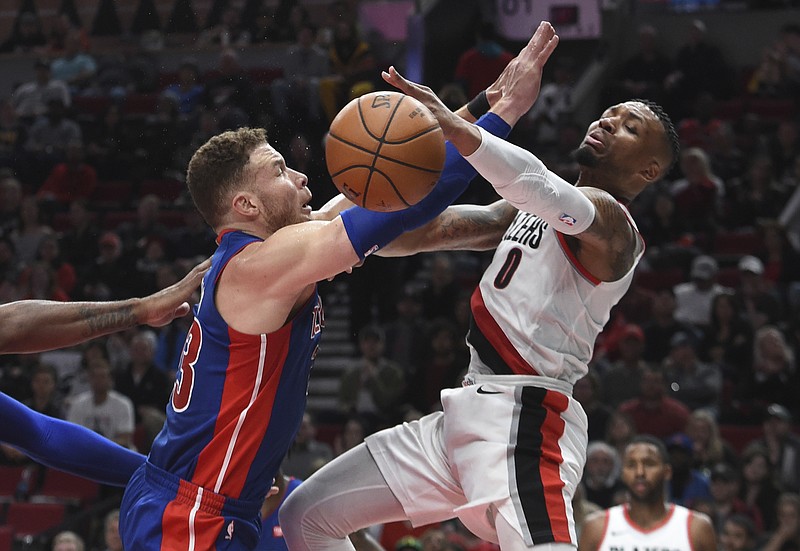 
              Portland Trail Blazers guard Damian Lillard is defended by Detroit Pistons forward Blake Griffin, left, during the second half of an NBA basketball game in Portland, Ore., Saturday, March 17, 2018. The Blazers won 100-87. (AP Photo/Steve Dykes)
            