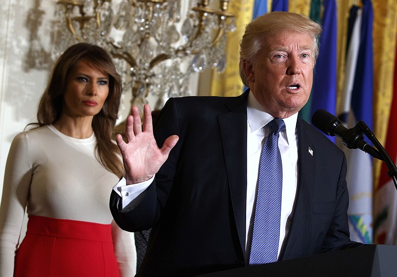 In this Friday, Oct. 6, 2017, file photo, President Donald Trump speaks during an event at the White House in Washington, as first lady Melania Trump listens. Trump's plan to combat opioid drug addiction calls for stiffer penalties for drug traffickers, including the death penalty where it's appropriate under current law. The president is scheduled to unveil his plan Monday, March 19, 2018, in New Hampshire, a state hard-hit by the crisis. He'll be accompanied by first lady Melania Trump, who has shown an interest in the issue, particularly as it pertains to children. (AP Photo/Evan Vucci, File)