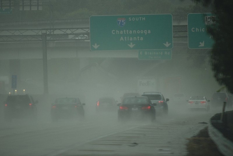 In this Sept. 11, 2017, staff file photo, Interstate 75 traffic is peppered by rain and wind from the outer bands of tropical storm Irma at the Highway 153 interchange in Chattanooga.
