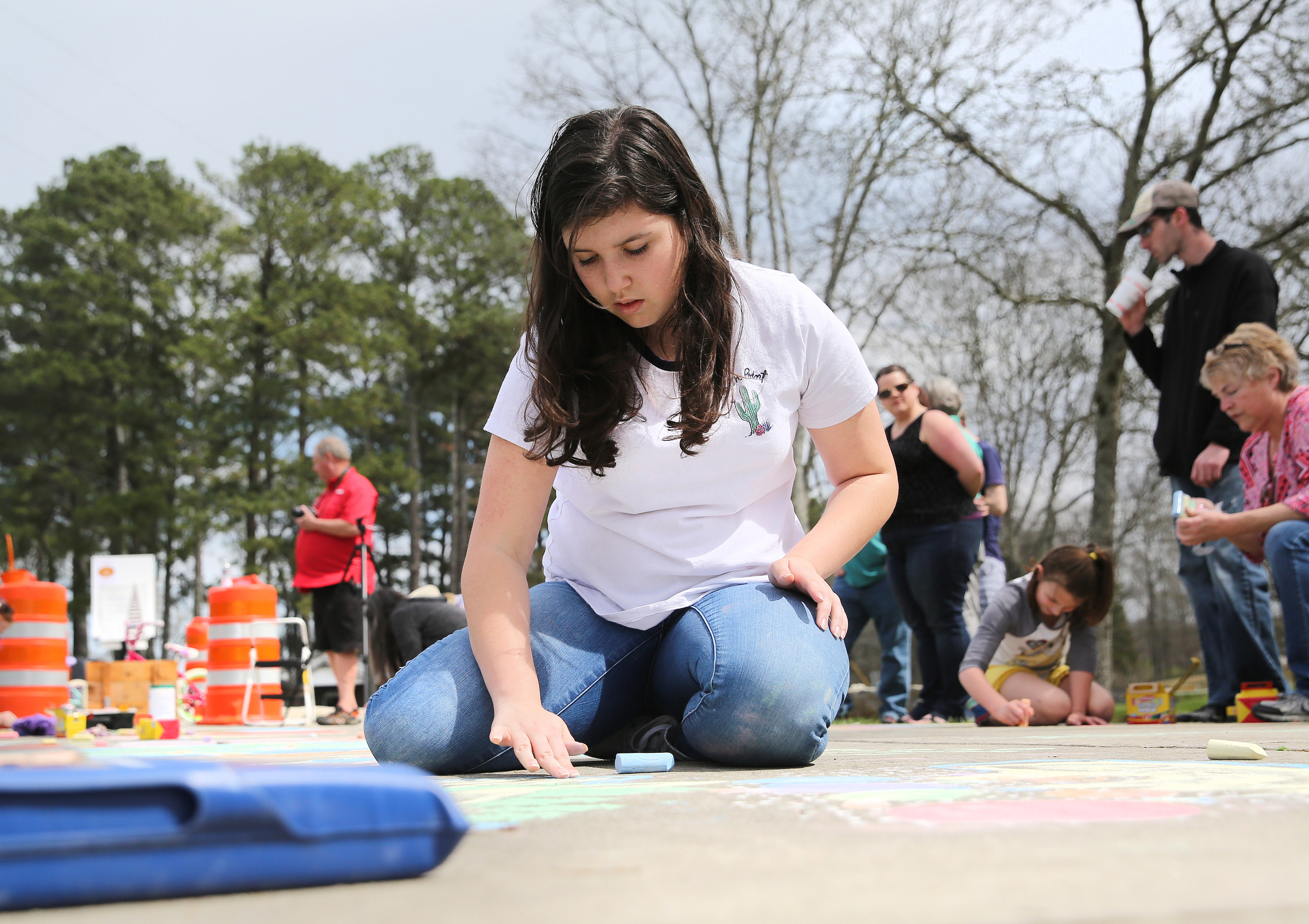 Trenity Newell, 15, draws with sidewalk chalk at Gilbert-Stephenson Park during an interactive art walk pop-up event Sunday, March 18, 2018 in Fort Oglethorpe, Ga. Fort Oglethorpe is one of four cities chosen this year by the Thrive Regional Partnership to receive strategic assistance for the next 10 months from Bridge Innovate design professionals and other community members.