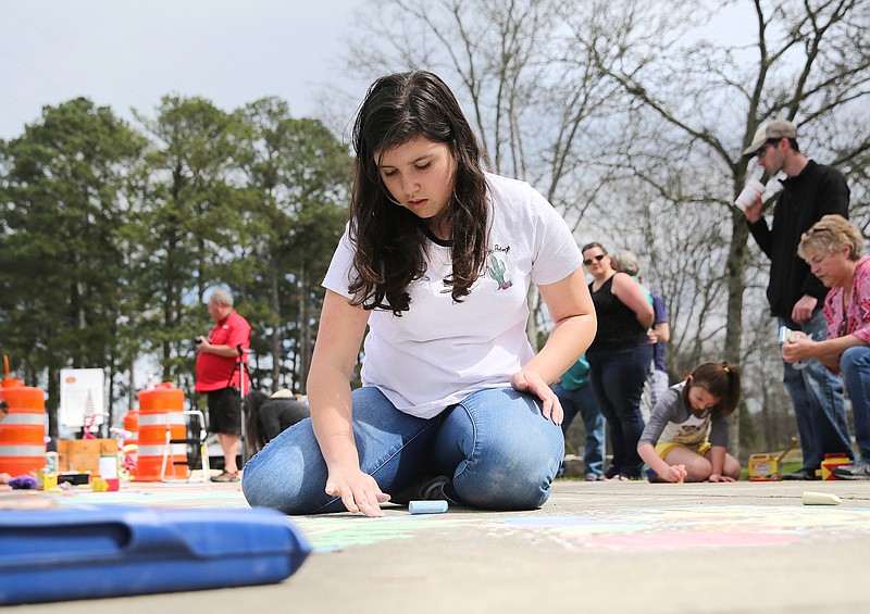 Trenity Newell, 15, draws with sidewalk chalk at Gilbert-Stephenson Park during an interactive art walk pop-up event Sunday, March 18, 2018 in Fort Oglethorpe, Ga. Fort Oglethorpe is one of four cities chosen this year by the Thrive Regional Partnership to receive strategic assistance for the next 10 months from Bridge Innovate design professionals and other community members.