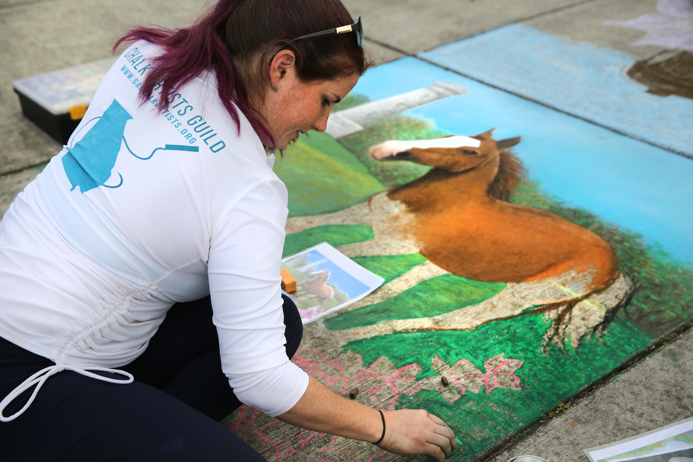Meg Mitchell creates a drawing with sidewalk chalk to illustrate different parts of Fort Oglethorpe at Gilbert-Stephenson Park during a Thriving Communities Initiative interactive art walk pop-up event Sunday, March 18, 2018 in Fort Oglethorpe, Ga. Mitchell, whose business Everlong Creative is out of Atlanta, was the featured artist for the event. Mitchell got her start in graphic design and commercial deign painting, but for the past three years she has focused more in chalk engraving, chalk lettering and calligraphy. Mitchell began her drawing at 11 a.m. and worked on it throughout the day while onlookers stopped by to check it out and create their own drawings.