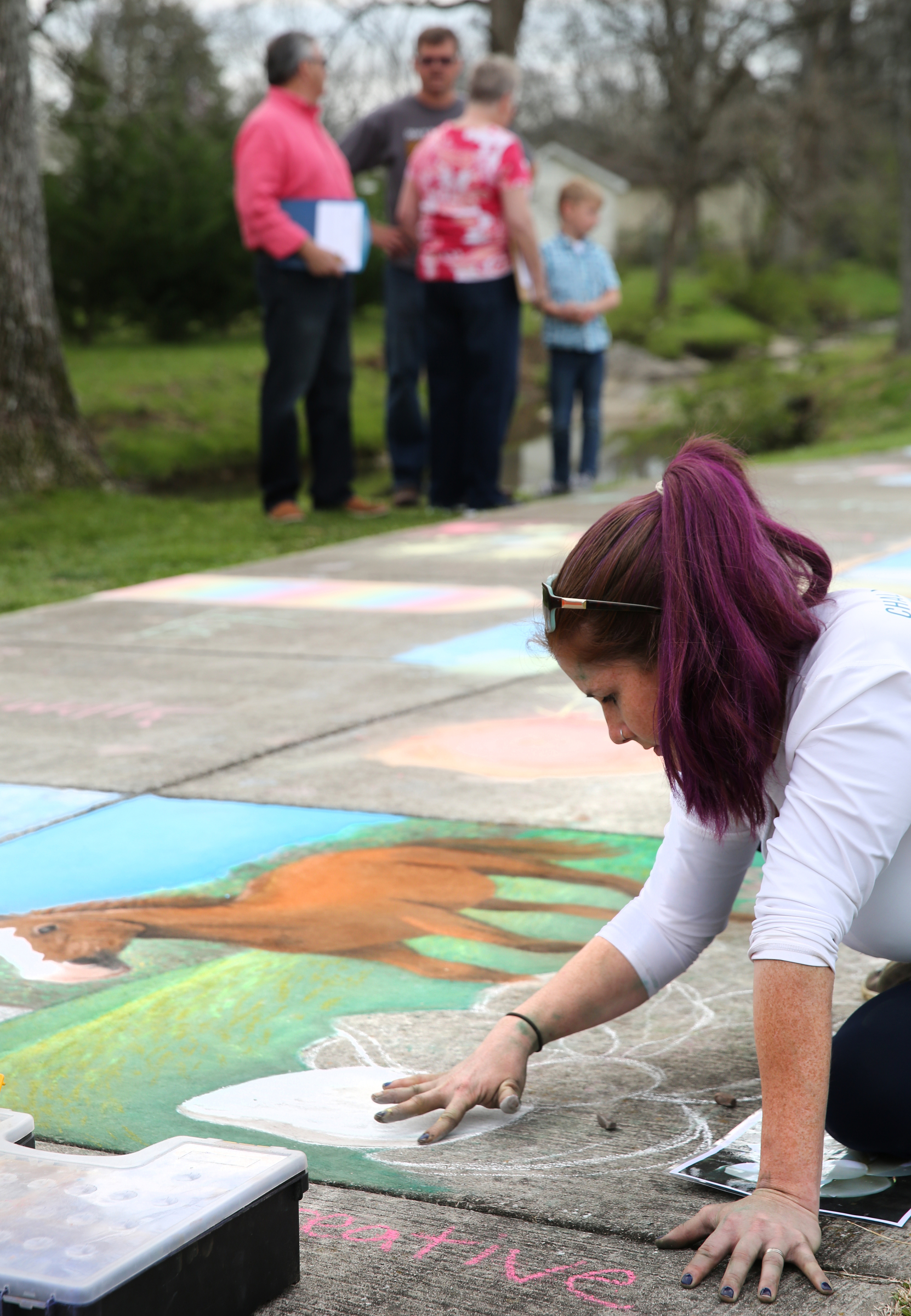 Meg Mitchell creates a drawing with sidewalk chalk to illustrate different parts of Fort Oglethorpe at Gilbert-Stephenson Park during a Thriving Communities Initiative interactive art walk pop-up event Sunday, March 18, 2018 in Fort Oglethorpe, Ga. Mitchell, whose business Everlong Creative is out of Atlanta, was the featured artist for the event. Mitchell got her start in graphic design and commercial deign painting, but for the past three years she has focused more in chalk engraving, chalk lettering and calligraphy. Mitchell began her drawing at 11 a.m. and worked on it throughout the day while onlookers stopped by to check it out and create their own drawings.