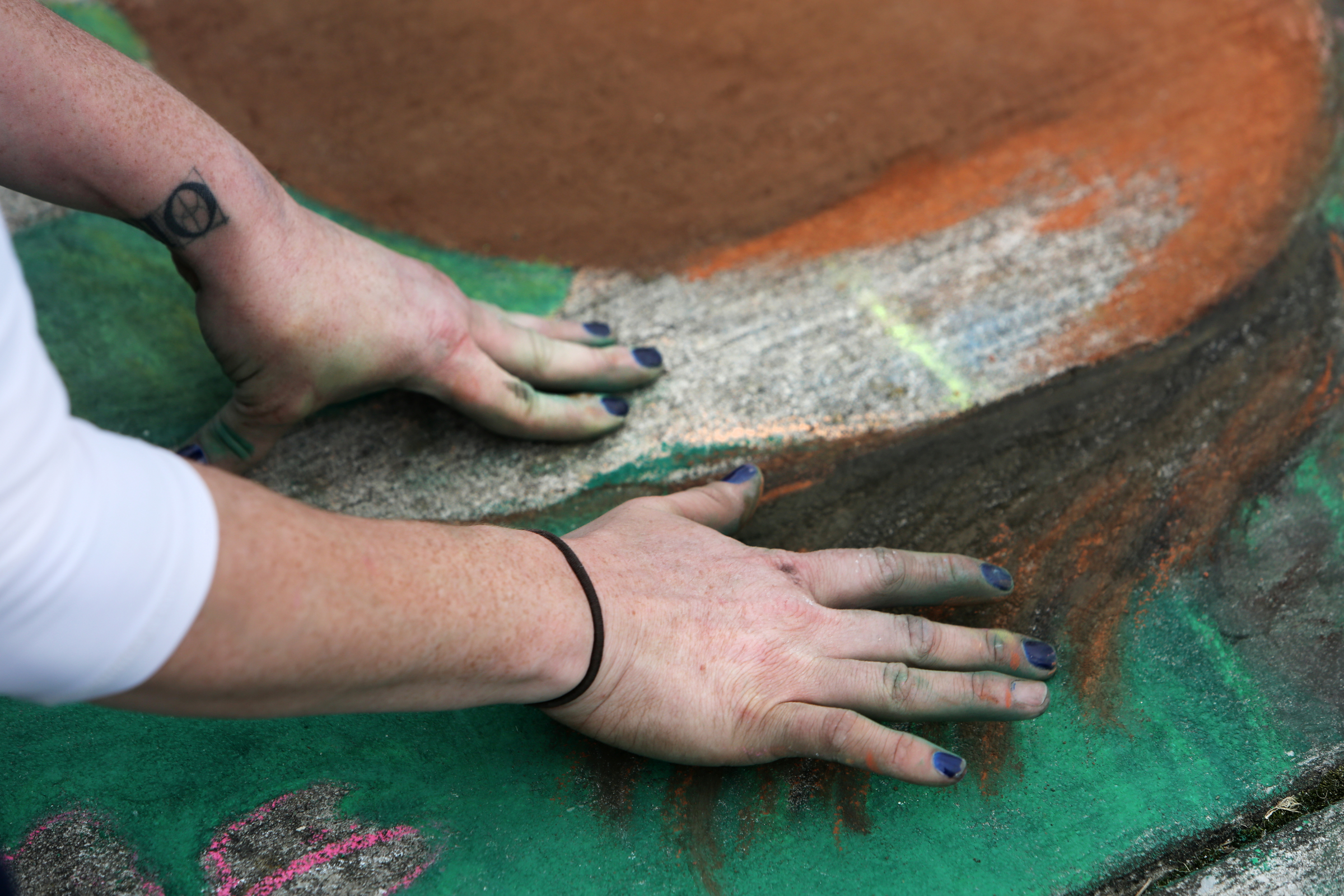 Meg Mitchell works on the horse portion of her sidewalk chalk drawing to illustrate different parts of Fort Oglethorpe at Gilbert-Stephenson Park during a Thriving Communities Initiative interactive art walk pop-up event Sunday, March 18, 2018 in Fort Oglethorpe, Ga. Mitchell, whose business Everlong Creative is out of Atlanta, was the featured artist for the event. Mitchell got her start in graphic design and commercial deign painting, but for the past three years she has focused more in chalk engraving, chalk lettering and calligraphy. Mitchell began her drawing at 11 a.m. and worked on it throughout the day while onlookers stopped by to check it out and create their own drawings.