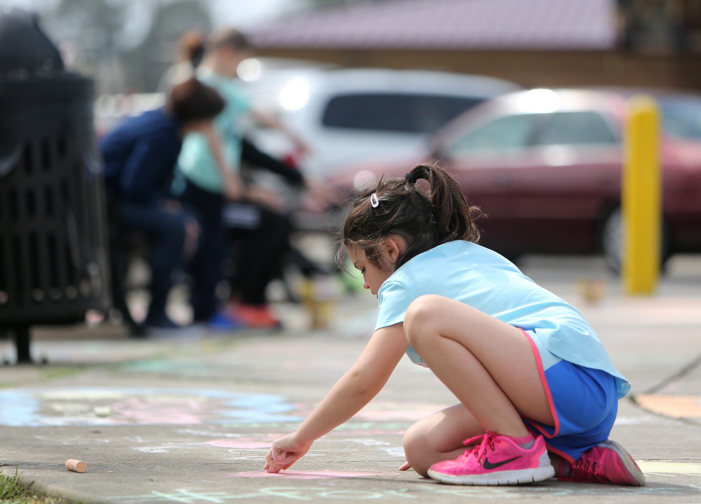 Emma Rigsby, 6, draws a butterfly with sidewalk chalk at Gilbert-Stephenson Park during a Thriving Communities Initiative interactive art walk pop-up event Sunday, March 18, 2018 in Fort Oglethorpe, Ga. The Thriving Communities Initiative helps Fort Oglethorpe leaders and volunteers enhance life in the city through arts and culture.