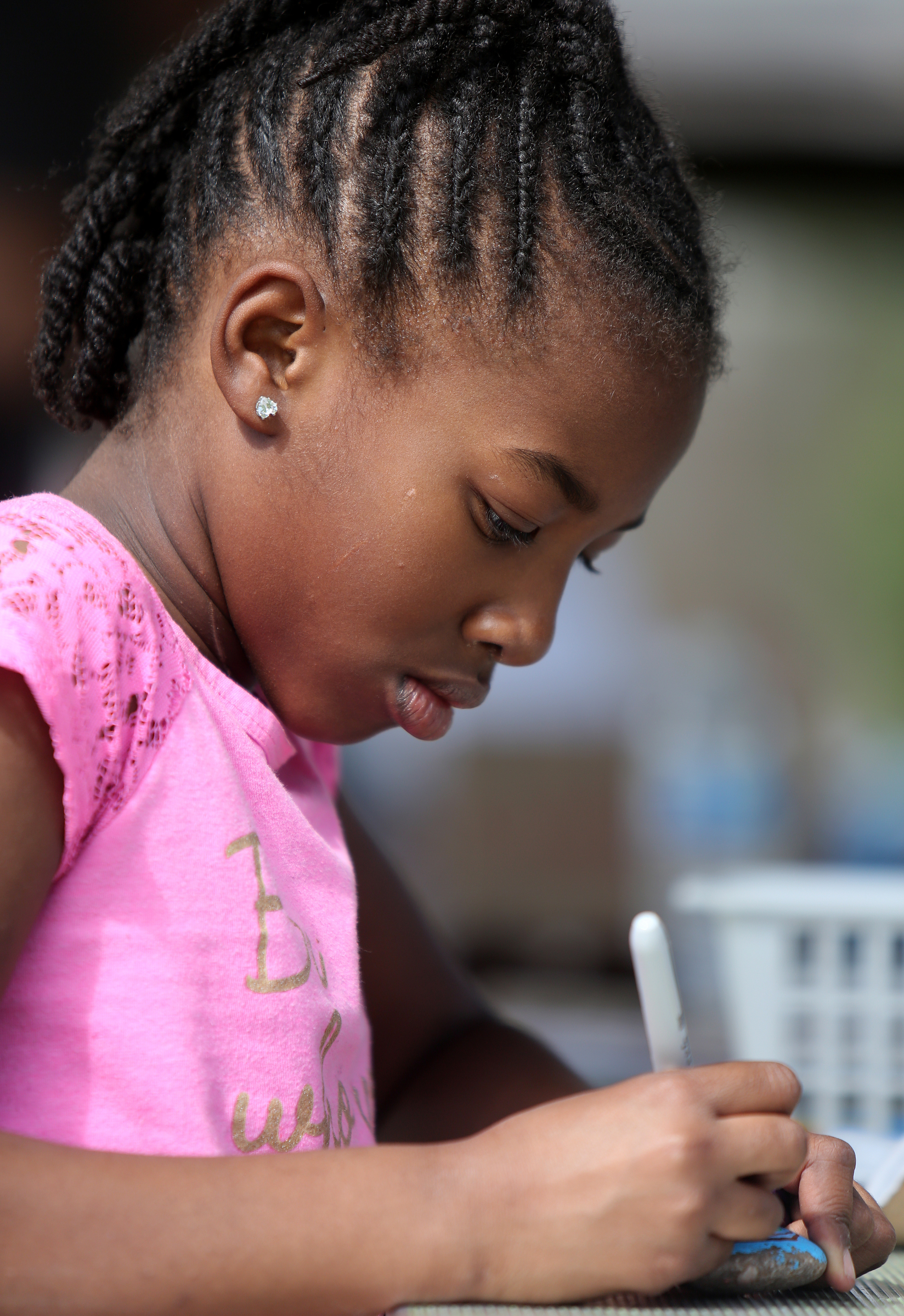 Niara Ayeni, 8, draws a heart and a rainbow on a rock at Gilbert-Stephenson Park during a Thriving Communities Initiative interactive art walk pop-up event Sunday, March 18, 2018 in Fort Oglethorpe, Ga. Fort Oglethorpe is one of four cities chosen this year by the Thrive Regional Partnership to receive strategic assistance for the next 10 months from Bridge Innovate design professionals and other community members.