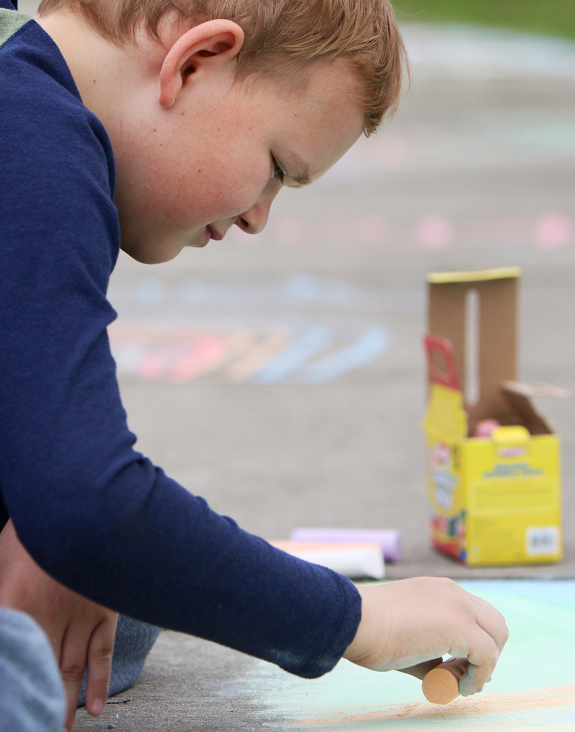 Gabriel Davis, 10, draws a sunset over mountains with sidewalk at Gilbert-Stephenson Park during a Thriving Communities Initiative interactive art walk pop-up event Sunday, March 18, 2018 in Fort Oglethorpe, Ga. Fort Oglethorpe is one of four cities chosen this year by the Thrive Regional Partnership to receive strategic assistance for the next 10 months from Bridge Innovate design professionals and other community members.