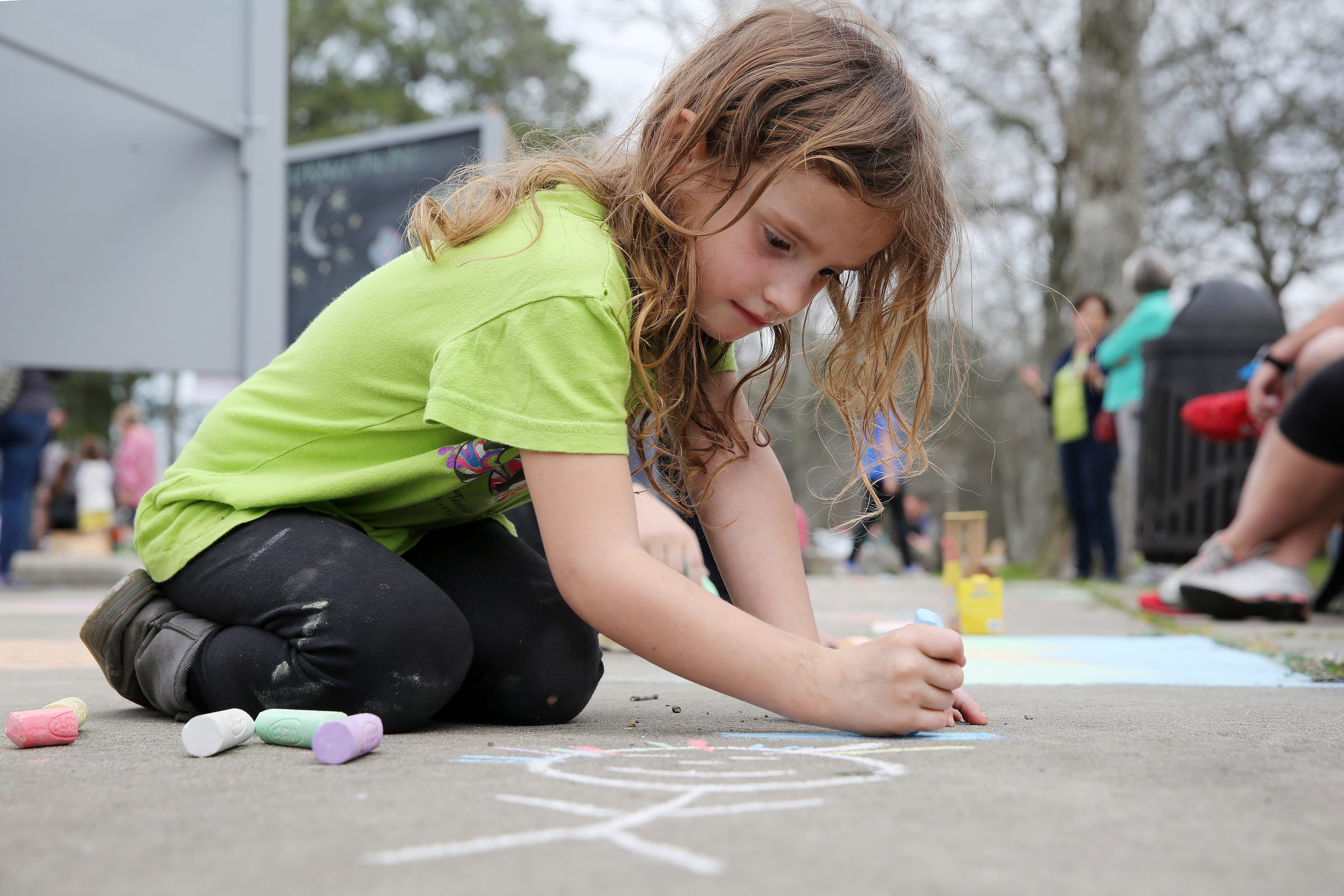 Aubrey Snyder, 4, draws a rainbow at Gilbert-Stephenson Park during a Thriving Communities Initiative interactive art walk pop-up event Sunday, March 18, 2018 in Fort Oglethorpe, Ga. The Thriving Communities Initiative helps Fort Oglethorpe leaders and volunteers enhance life in the city through arts and culture.